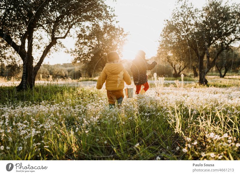 Brother and sister walking on flower meadow Brothers and sisters Together togetherness Child childhood Authentic Family & Relations Life Happiness Happy
