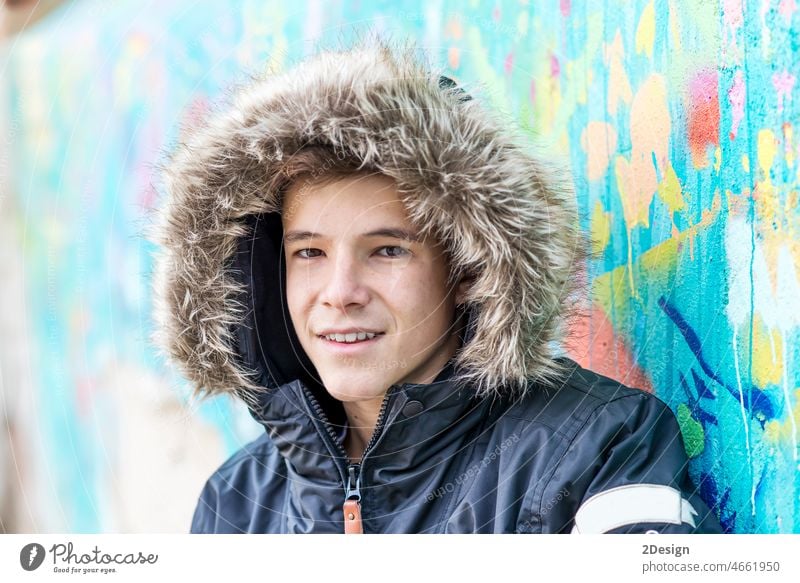 Portrait of smiling boy with hooded jacket looking at camera headshot one person teenager front view fur people photography color image portrait boys confidence