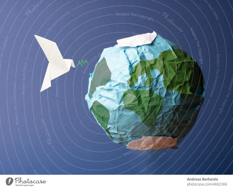 Abstract globe made of crumpled paper with origami peace dove pigeon freedom diamond crystal world earth stone gem conceptual worthy symbol design icon recycle