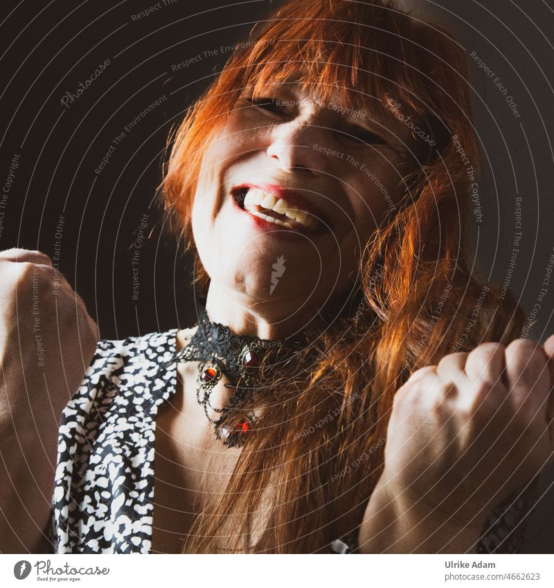 1000|Woman is happy about the victory Joy Sieg glorious Thumbs up Laughter zest for life red hair Happy portrait Happiness Face Smiling Positive people Cheerful