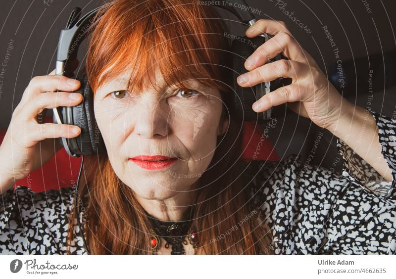 Soundcheck - woman puts on headphones and looks expectantly soundcheck Listen to music Headphones Woman Red-haired To put on portrait Music Listening To enjoy