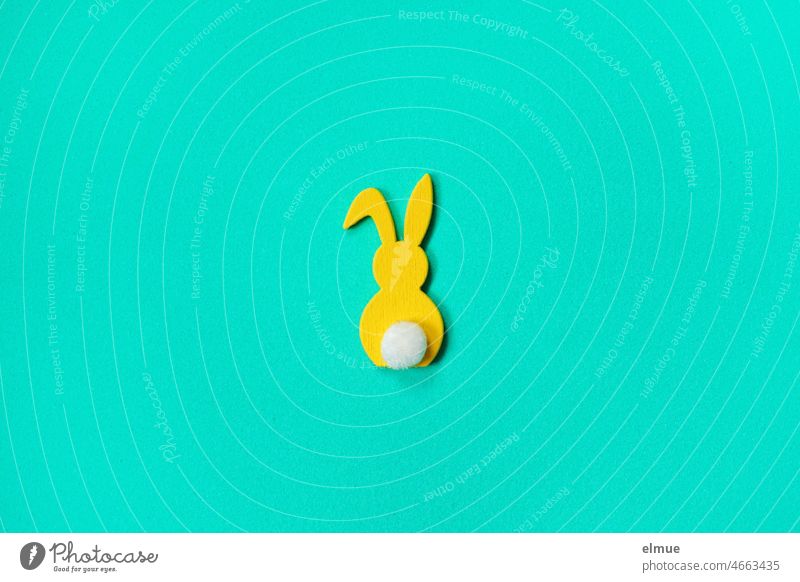 stylized yellow bunny with white flower and bent ear on cyan background / flatlay Easter Bunny Hare & Rabbit & Bunny Yellow Flower kink in the ear Hare ears