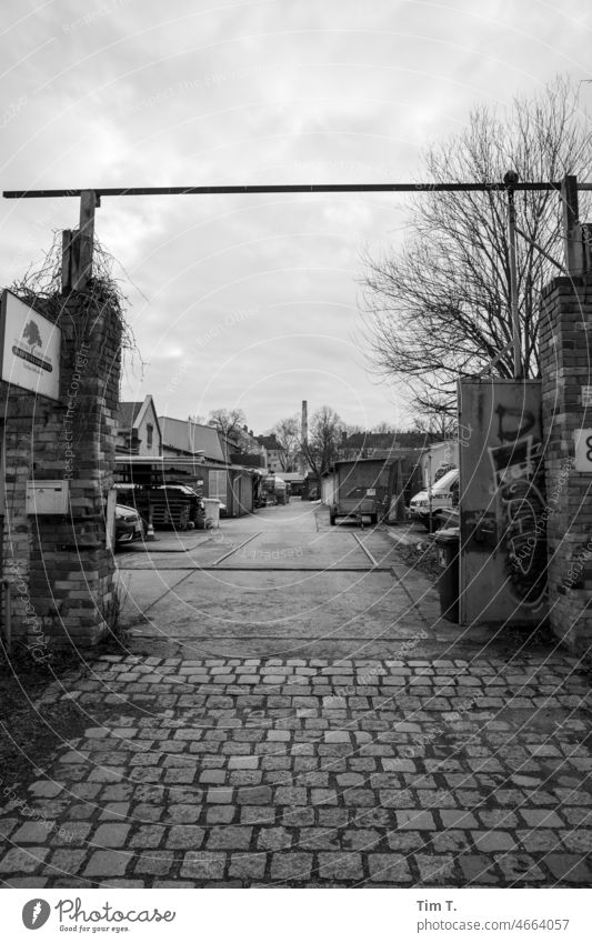 a yard with many workshops Berlin Winter Lake Weißensee b/w Black & white photo Exterior shot Deserted Town Downtown Capital city Day Architecture