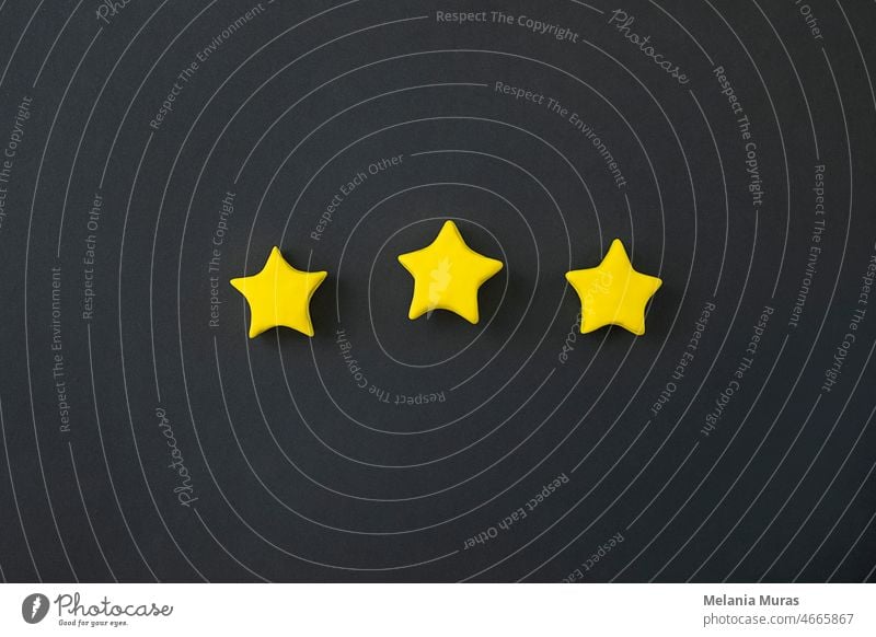 Three golden star on black background. Golden star shape. Concept of top class, best quality product symbol. Sign of  evaluation, feedback from customer. 3d 5