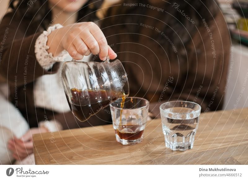 Unrecognizable women pouring filter coffee at cafe. Girls meeting in cafe to drink coffee and talk. Millennial lifestyle. restaurant woman beautiful cup happy