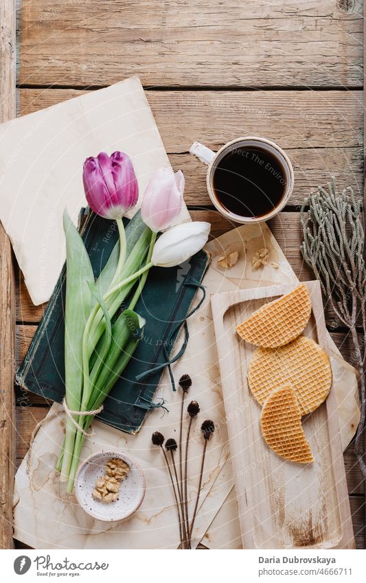 coffee, waffles and tulips on a wooden table flower tasty view cafe espresso aroma closeup concept spring fresh bouquet breakfast hot caffeine top mug black