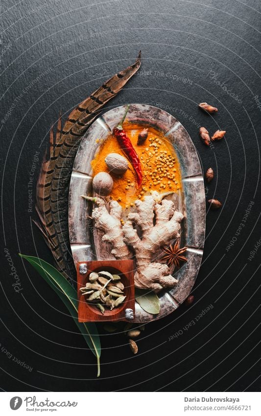 fragrant spices in a metal plate on a black background nutrition culinary vegetarian allspice bowl aroma indian natural spicy close-up colorful macro condiment