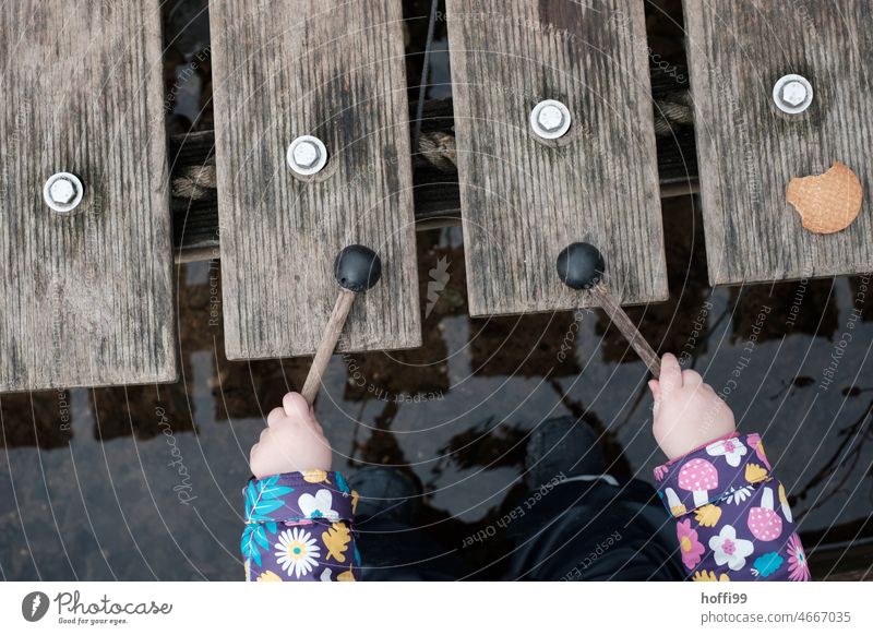 a child plays xylophone on a bridge - the cookie is already waiting Xylophone Child Music play music Musician Music Education Sound Musical instrument