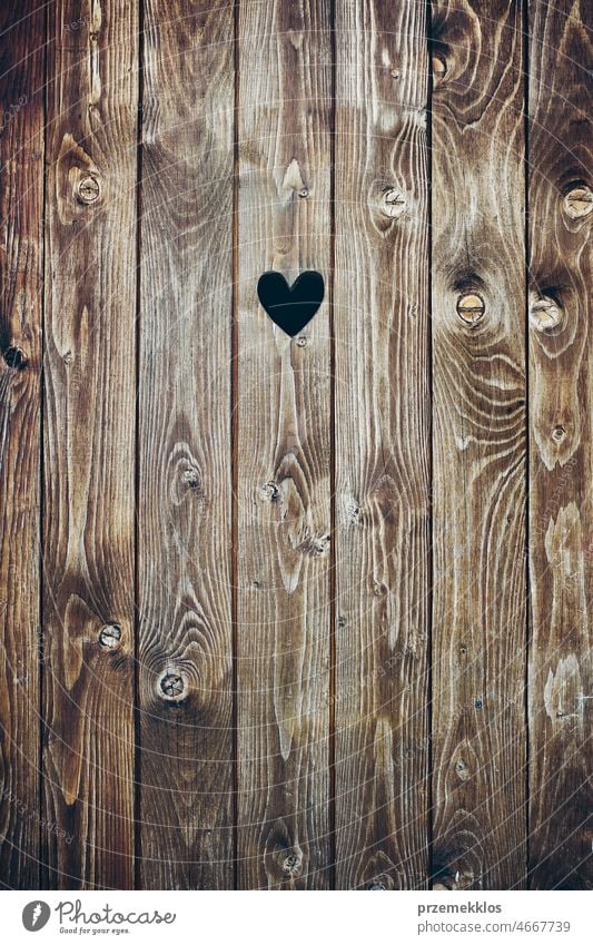 Wooden door with heart shape hole. Wood plank background wood rustic wooden timber texture rough old pattern dark brown grain grunge grungy hardwood material