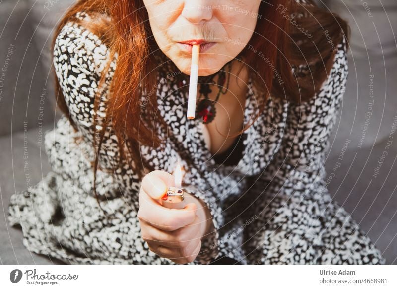 Woman with red long hair is about to light a cigarette with the help of a lighter Debauchery Unhealthy Dependence Health hazard Tobacco Filter-tipped cigarette