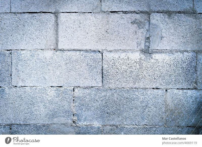 Natural gray brick texture. Concrete block wall background. stone cement grout old antique rural construction building site close-up uneven concrete material