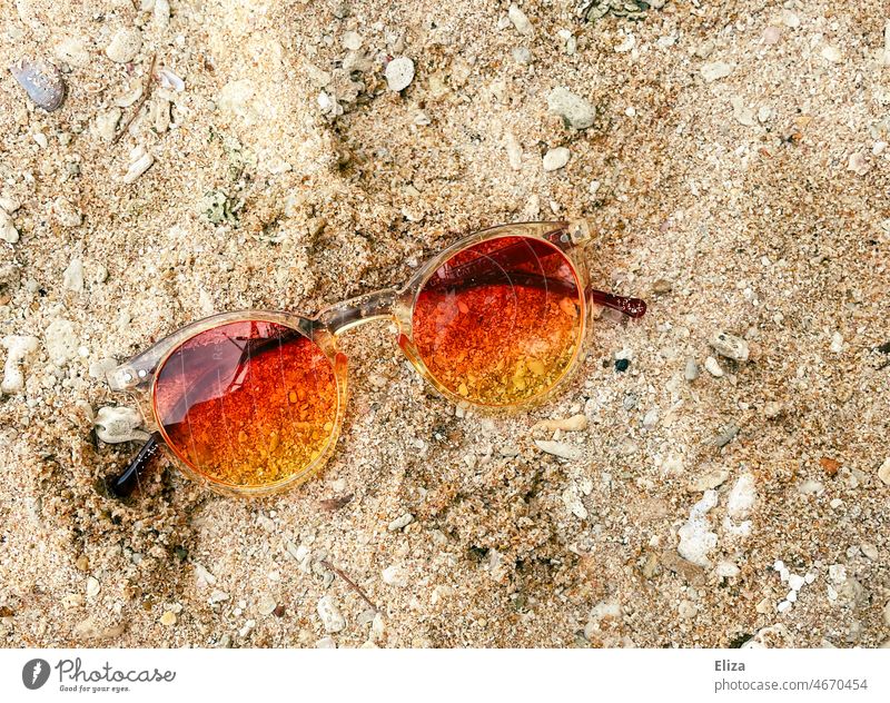 Orange red tinted sunglasses in the sand Sunglasses Red vacation Sand Vacation mood Beach Summer Vacation & Travel sunshine Good mood colourful Summer vacation