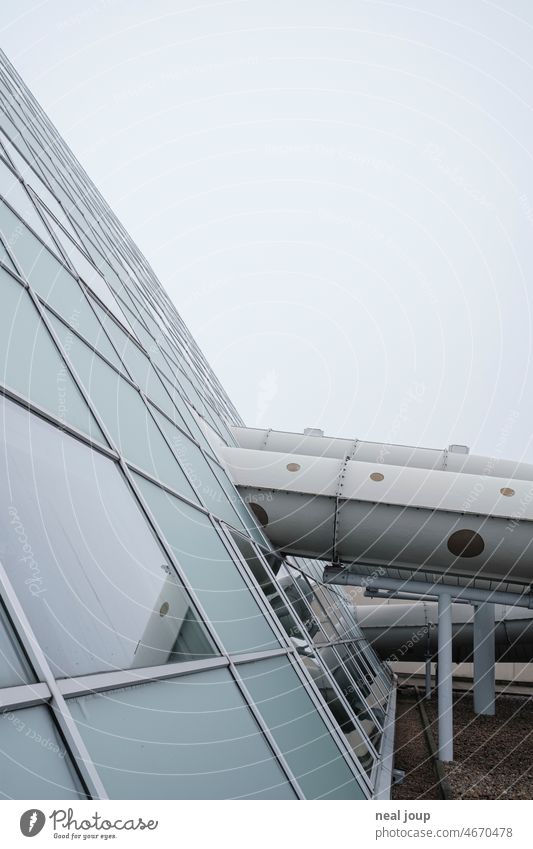 Tubes of a water slide penetrate the facade of steel and glass Architecture Structures and shapes structure Glass Steel Gray tube geometric composition