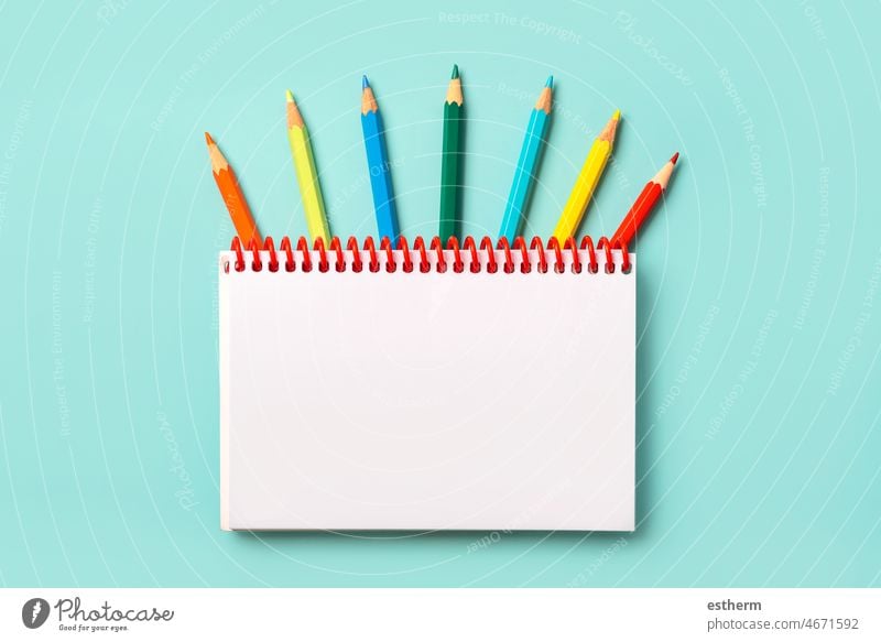 Spiral notebook with colored pencils and with space for your picture or text Spiral notepad back to school Education Memo Room pages Text crayons University
