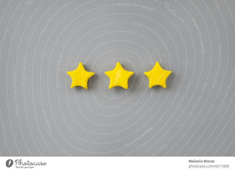 Three golden star on neutral background. Golden star shape. Concept of top class, best quality product symbol. Sign of  evaluation or feedback from customer. 3d