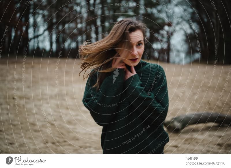 Portrait of woman with motion blur and blowing hair Movement portrait Strand of hair Face of a woman Adults melancholy Dream Feminine Young woman Mysterious
