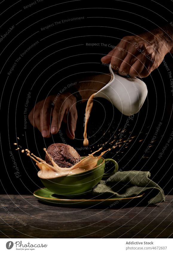 Unrecognizable person throwing cookies into cup dessert sweet coffee hot drink breakfast splash caffeine fresh kitchen tasty delicious table energy food
