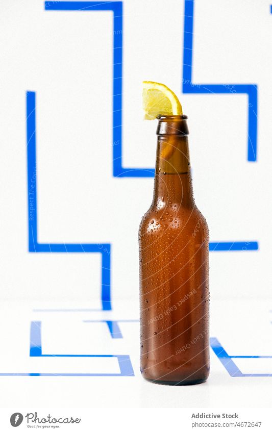 Opened bottle of cold beer with slice of lemon drink beverage refreshment glass citrus liquid cocktail tasty natural vitamin thirst fruit alcohol delicious