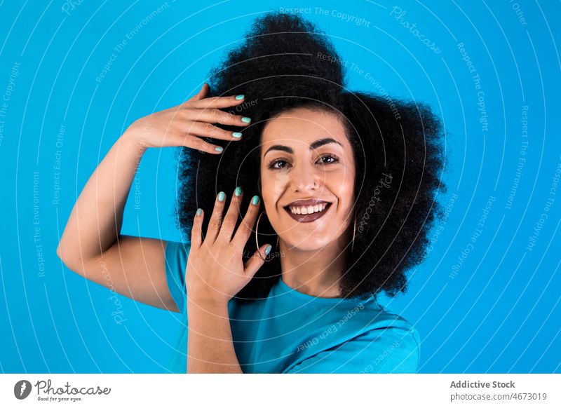 Happy hispanic woman with Afro hairstyle afro smile fashion trendy happy appearance delight feminine casual glad attractive charming studio model female