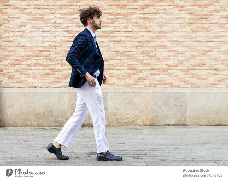 Elegant Hispanic man near brick wall style city street elegant suit walk formal appearance urban stroll male confident hispanic handsome beard trendy mustache