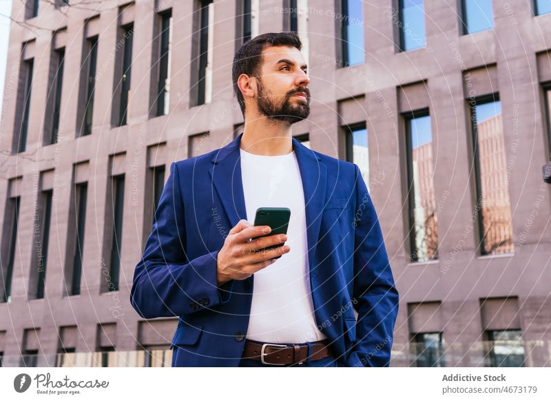 Positive businessman browsing on mobile phone entrepreneur street city urban building text message communicate surfing smartphone concentrate focus cellphone
