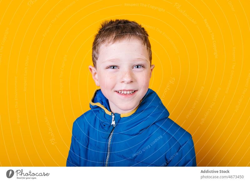 Boy in outerwear looking at camera boy cute child appearance portrait colorful bright warm clothes little kid coat vibrant casual adorable human face blue eyes