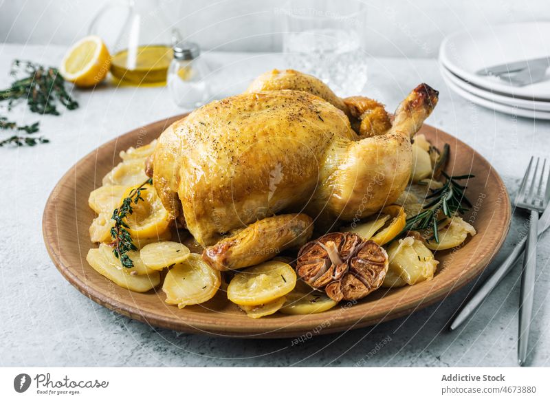 Delicious roasted chicken with potatoes and condiments food gastronomy meal gourmet lemon thyme delicatessen delicious culinary fine dining dinner lunch cuisine