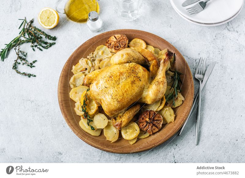 Delicious roasted chicken with potatoes and condiments food gastronomy meal gourmet lemon thyme delicatessen delicious culinary fine dining dinner lunch cuisine