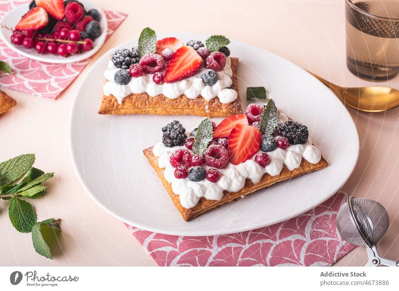 Delicious puff pastry tart with berries berry topping whipped cream dessert sweet calorie confection homemade food yummy mint tasty delicious treat kitchen