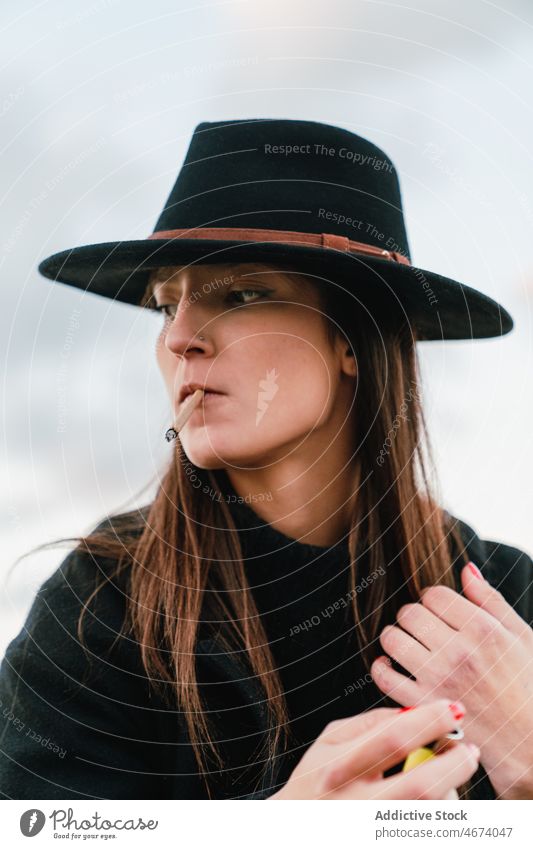 Woman in hat smoking cigarette woman smoke smoker habit street style nicotine tobacco addict joint female lady town light appearance unhealthy attractive glad