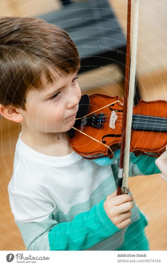 Little boy playing violin at music class child little lesson musician instrument education bow kid school study classroom childhood classic practice talent