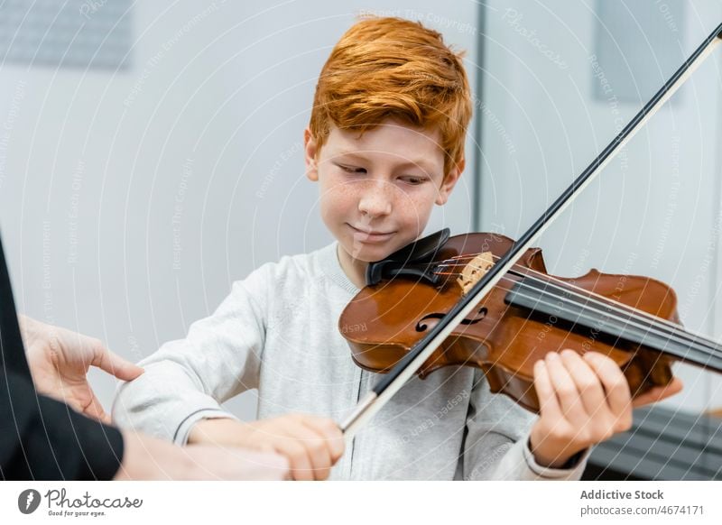 Smiling boy playing violin in music school lesson melody child class musician cheerful learn kid talent practice content happy classroom inspiration positive