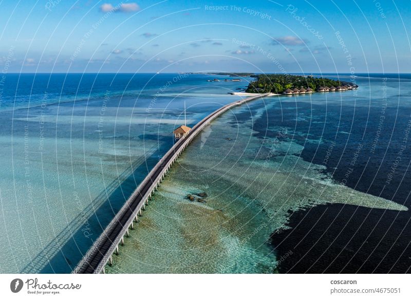 Aerial view of a walkway in a luxury resort in the Maldives above aerial beach beachfront beautiful birds eye view bungalow coastal drone empty footway high