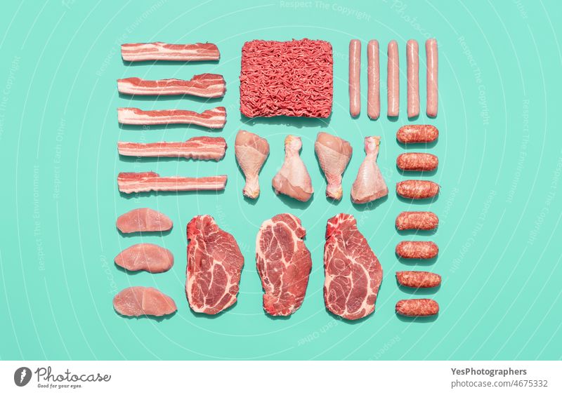 Raw meat variety isolated on a green background, top view. above aligned arranged assortment bacon barbeque bbq beef breast bright butcher chicken color cuisine