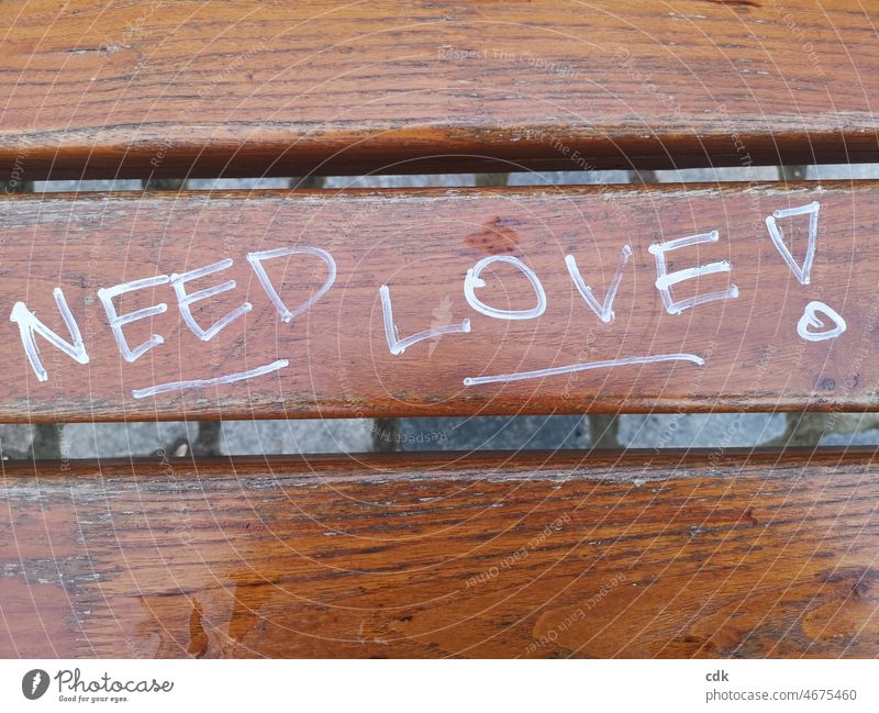 NEED LOVE! lettering writing Park bench Exclamation mark Underlines Graffiti Remark Information upper-case letters English described seat Sign "need love!"
