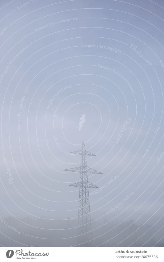 Newly built power pole for 380kv in the middle of nature in the fog stream Electricity pylon Steel Steel construction Power consumption power line power supply