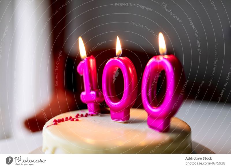 Cake with candles with number 100 cake birthday hundred hundredth anniversary burn light celebrate sweet festive event party dessert holiday delicious table