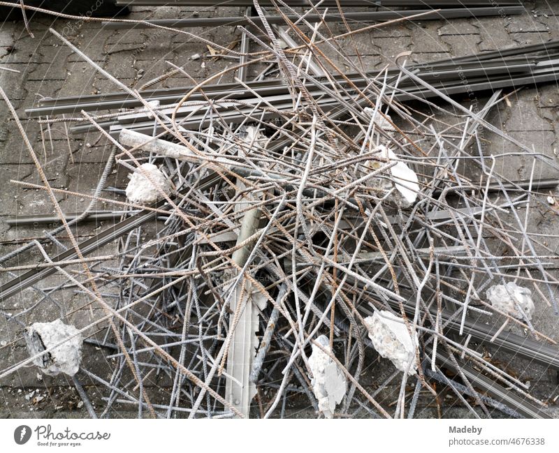 Old bent wires for concrete construction and construction debris on the cobblestones at a construction site on Hanauer Landstraße in the Ostend district of Frankfurt am Main in the German state of Hesse