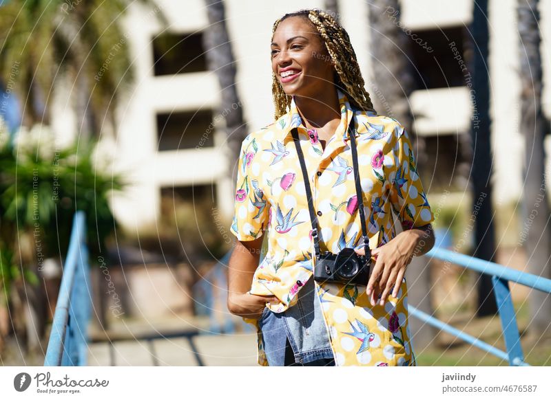 Smiling black woman with photo camera in city photographer summer smile style street positive photography female african american ethnic cool content cheerful