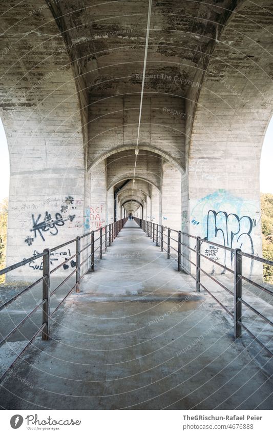 Concrete bridge with iron railing graffiti Perspective Bridge bows Center point