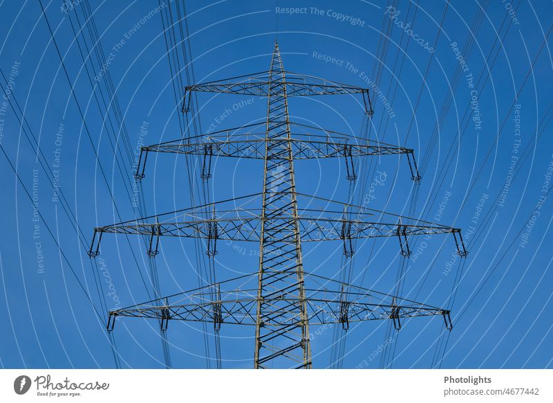 High voltage pylon for suspension of overhead electric line High voltage power line Sunbeam Sunlight Cloudless sky Ecological Clean Climate change Eco-friendly