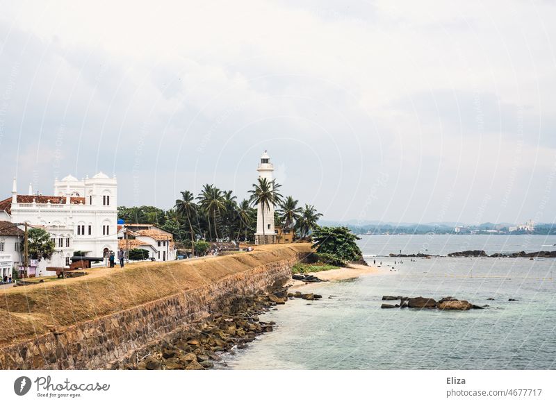 Lighthouse and colonial style building on the coast of Galle city in Sri Lanka gall White palms tropics Ocean Sky Town Landscape Building Architecture