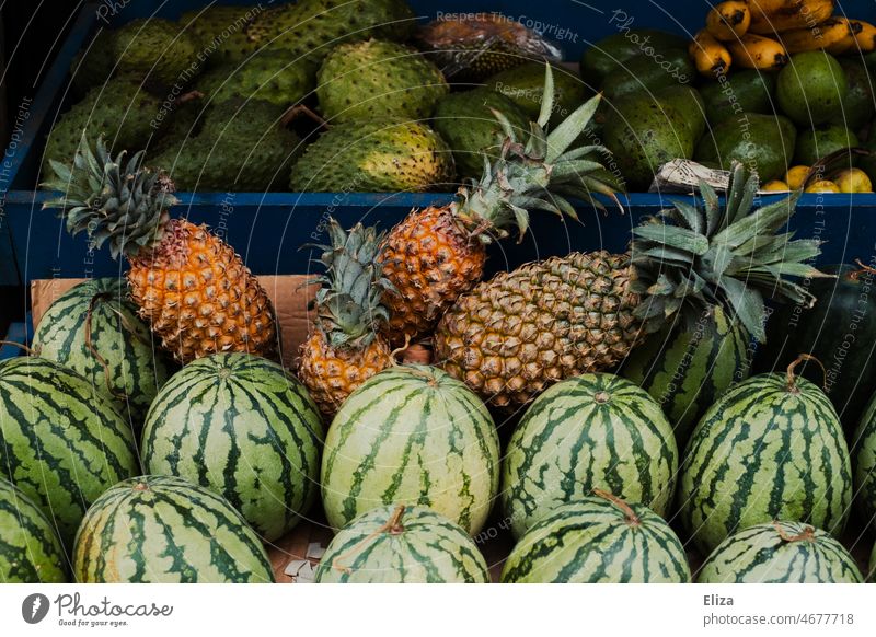 Pineapple, watermelon and other tropical fruits at a fruit stand Watermon Tropical Market stall Delicious Asia Exotic Food salubriously vegan