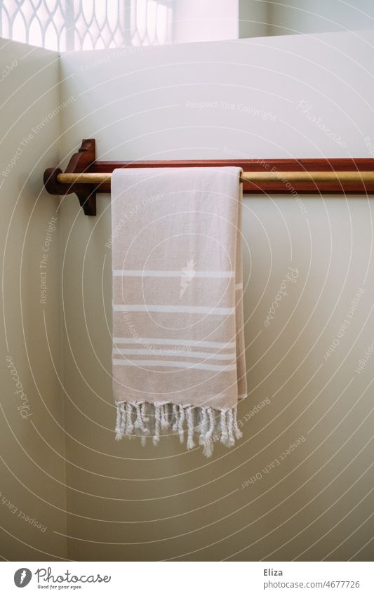 Towel on towel rack on white wall in bathroom Hammam cloth Towel rack pole White Bath towel oriental Bathroom Striped Bright Spa