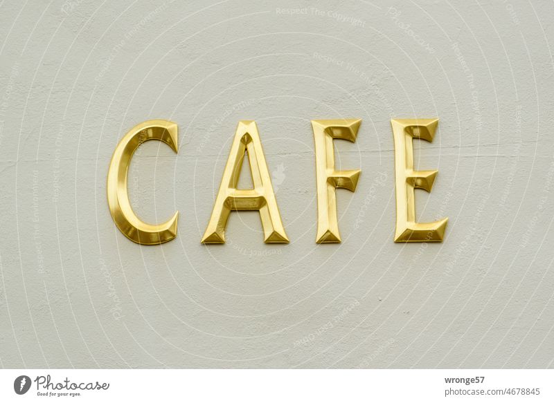 CAFE in golden letters on a house wall Café Letters (alphabet) upper-case letters Facade House front Characters Deserted Colour photo Typography Word writing