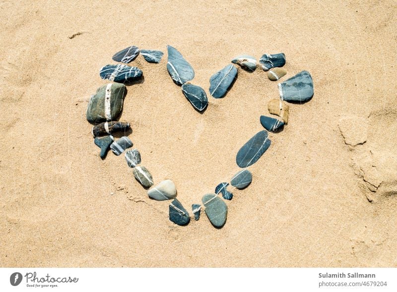 Heart from stones in sand Sign Natural material Sand Stone symbol Affection Sincere positive emotion Positive romantic love fall in love have a crush Love