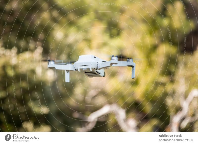 White drone flying in countryside uav unmanned tree aircraft modern system device summer nature rural environment technology electronic flight summertime motion