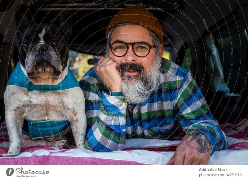 Mature man with dog in camper french bulldog elderly countryside van road trip animal owner mature pet canine purebred summer parked breed pedigree obedient