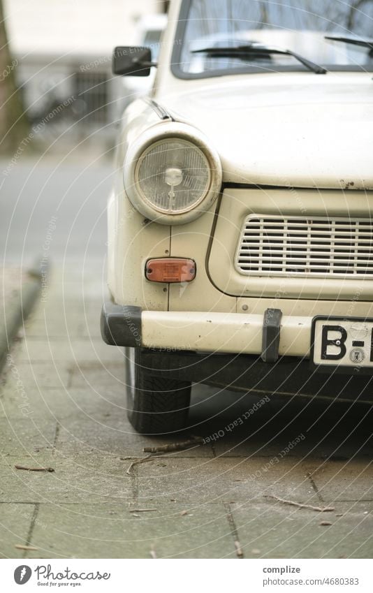 Front view of a beige Trabant (Trabi) with Berlin license plates on a parking lot in a street, in the middle of winter trobant East berlin east berlin west