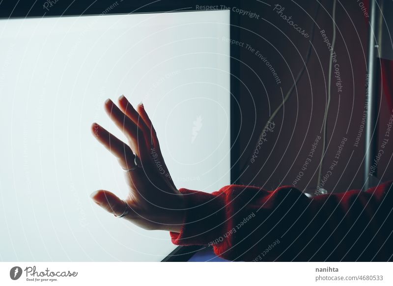 Hand touching a white screen concept computer technology human hand hacker distance addiction addictive pc electricity led energy mystic future progress
